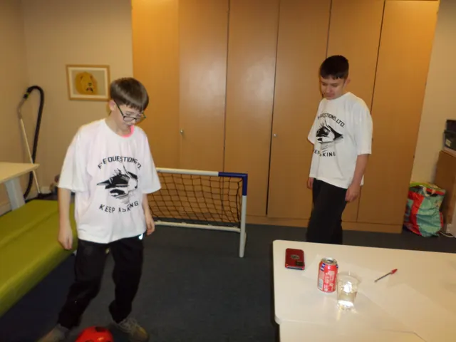 Two young people in JADAMSACADEMY t-shirts playing a game during a session