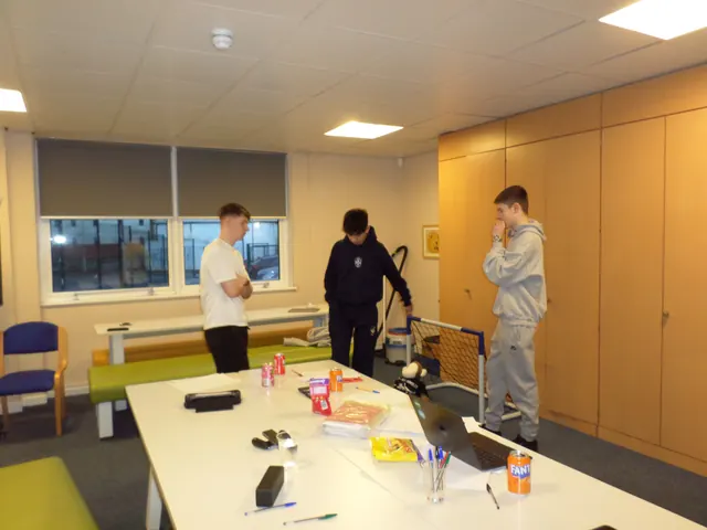 Young people at a JADAMSACADEMY session in a community room with snacks and a laptop on the table